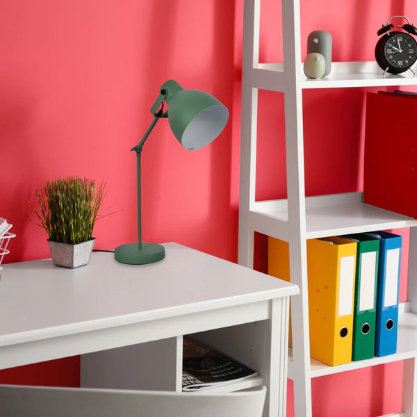 A green desk lamp illuminates a study space. The bright light showcases a modern, minimalist design.