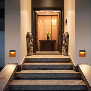 Warm lighting illuminates the steps and walls, creating an inviting and elegant entrance ambiance.