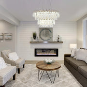 A multi-tiered crystal chandelier provides the focal point in this bright living room, creating a luxurious ambience.