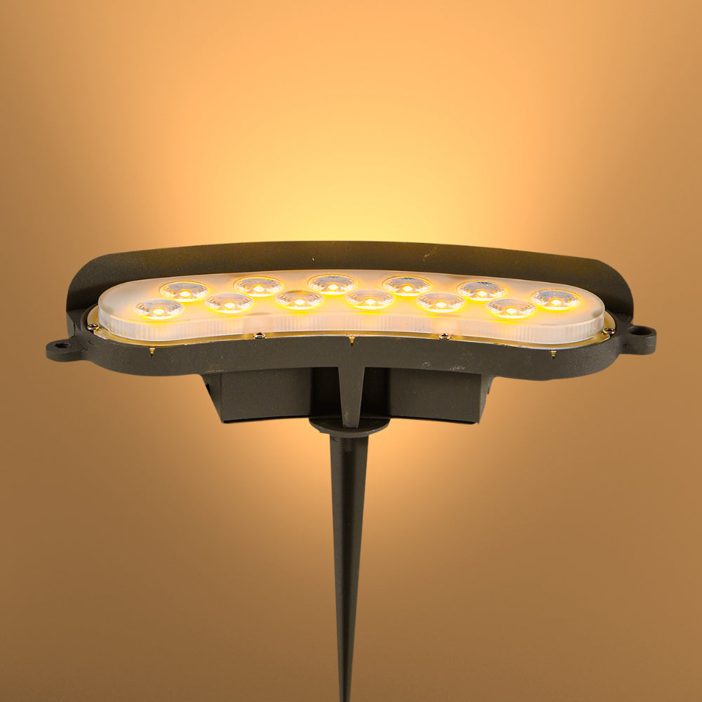 Световой проектор LED с теплым белым и зеленым светом, идеален для освещения садов и парков в современном ландшафтном дизайне.