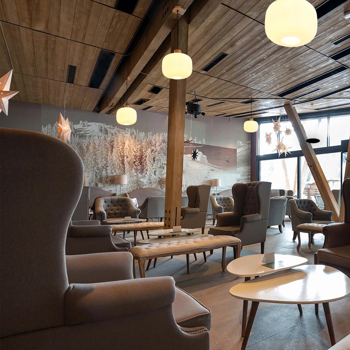 This interior features three pendant lights with spherical, opal glass shades, which create a warm, inviting glow. Additional star-shaped lights add charm.